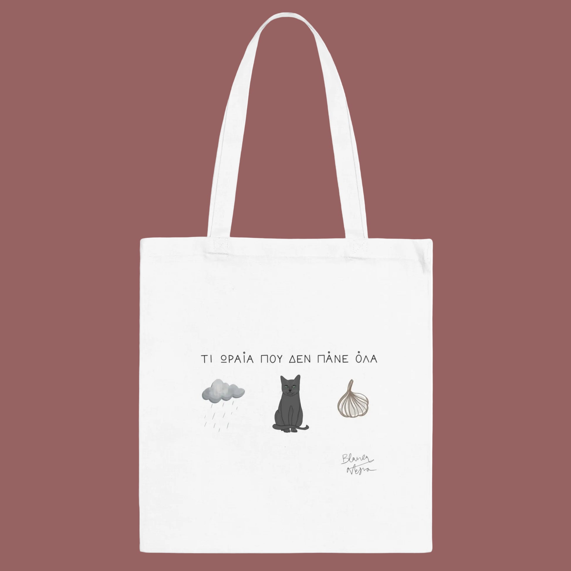 White tote bag with cat illustration and text on a white background