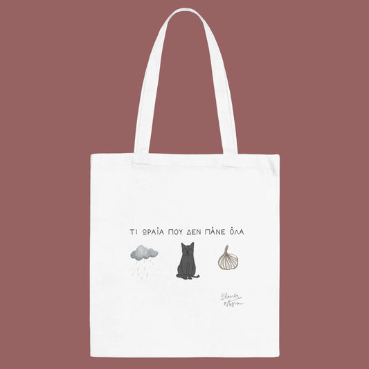 White tote bag with cat illustration and text on a white background