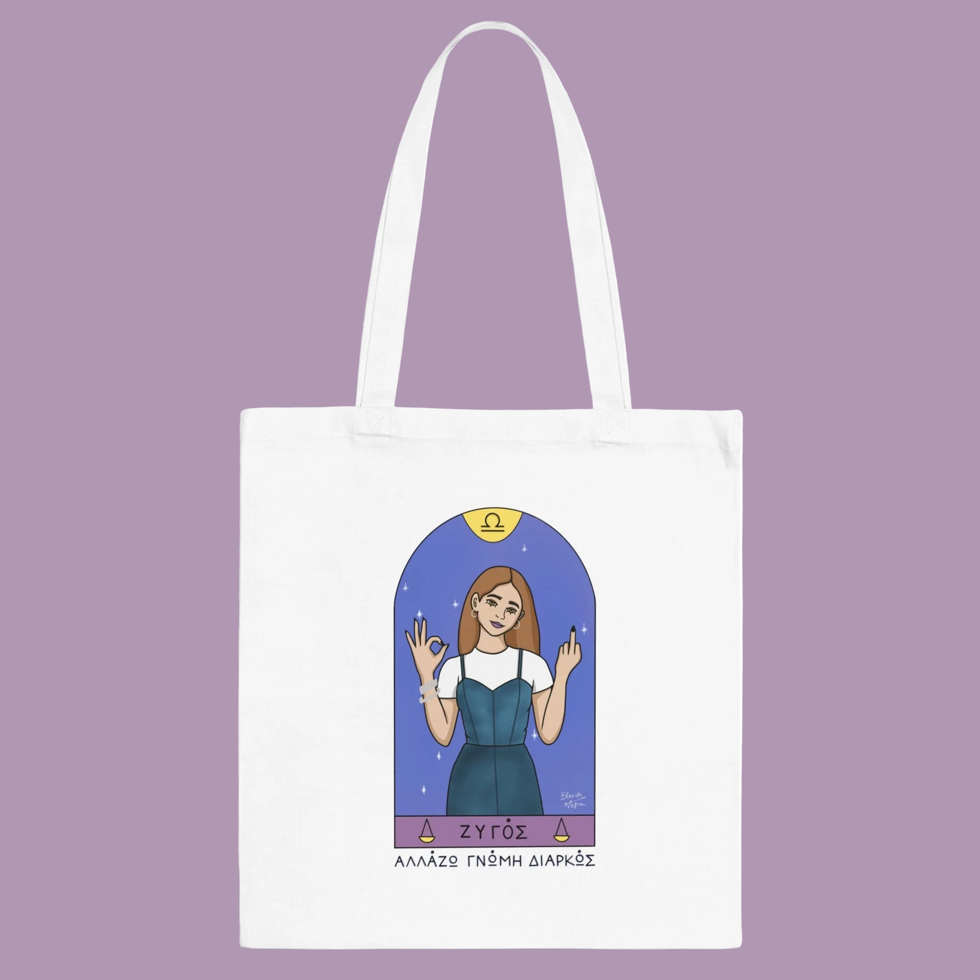 White tote bag with an illustration of a woman in a blue dress and 'ZYGOS' branding on a white background