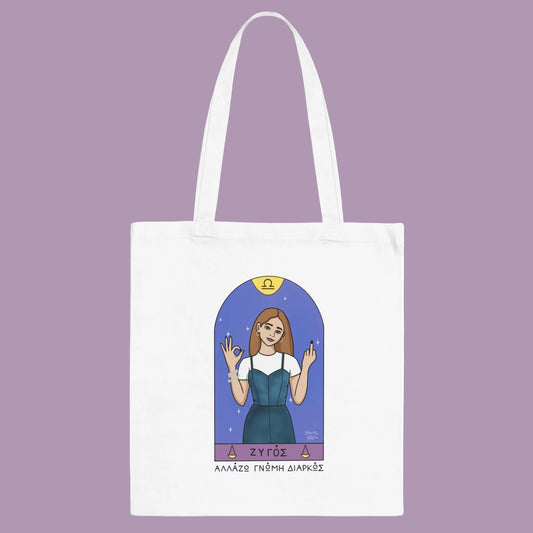 White tote bag with an illustration of a woman in a blue dress and 'ZYGOS' branding on a white background