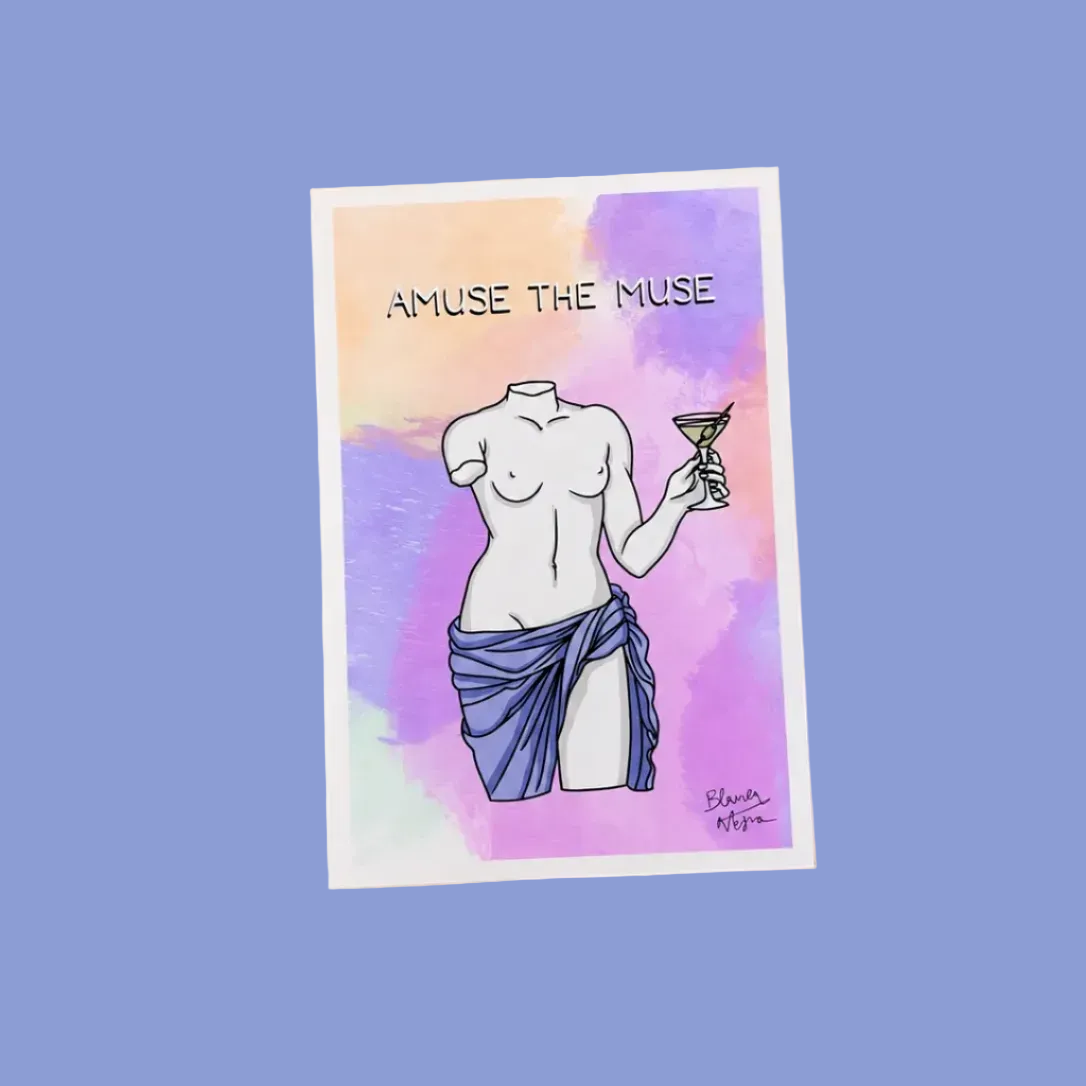 A vertical art print featuring an illustration of a draped female torso holding a martini glass, with the text 'AMUSE THE MUSE' at the top. The print is shown at an angle against a solid light peach background.