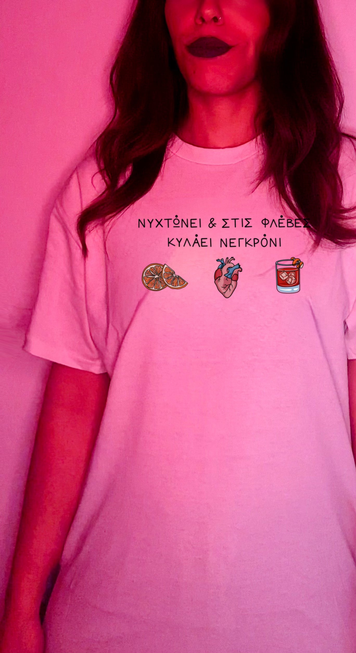 A person wearing a white crew neck t-shirt with a printed design that includes text and illustrations related to the Negroni cocktail.